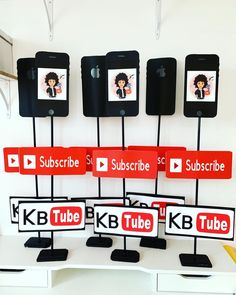 several cell phones are on display with red and black signs in front of them that say subtube