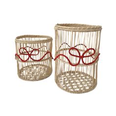 two white baskets with red ribbons on them