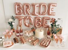 a table topped with lots of balloons and desserts next to a sign that says bride to be