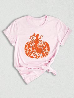 a pink shirt with an orange pumpkin on it