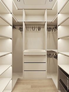 an empty walk in closet with lots of white shelves