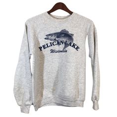 "PELICAN LAKE WISCONSIN Gay Fish Sweatshirt Size S ITEM DESCRIPTION: This sweatshirt will be perfect for all your outdoor activities. Material: 50% Cotton 50% Polyester Made in USA APPROXIMATE MEASUREMENTS: Pit To Pit: 19\" Sleeves: 27\" Length (neck to bottom): 22\" ITEM CONDITION: Vintage Condition (Small stain on the front low right side look at the last pic). ABOUT PELICAN LAKE: Pelican Lake offers some of Wisconsin's finest fishing and boating lakes. At 3,585 acres and a maximum depth of 39 Sporty Crew Neck Top For Outdoor, Sporty Crew Neck Sweatshirt For Outdoor, Gray Crew Neck Top For Outdoor Activities, Gray Crew Neck Top For Outdoor, Crew Neck Tops For Sports Season Outdoor Activities, Crew Neck Top For Outdoor Activities, Cotton Sweatshirt For Sports Season Outdoor Activities, Cotton Sweatshirt For Outdoor Activities, Cotton Sweatshirt For Outdoor Activities During Sports Season