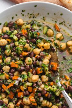 a white bowl filled with beans and vegetables