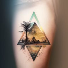 an image of a tattoo on the side of a woman's stomach with pyramids and palm trees