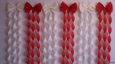 red and white streamers with bows hanging on the wall