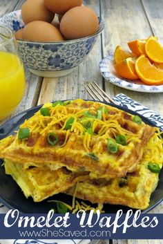 an omelet waffle on a plate with oranges and juice