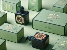 several different types of soaps and bottles on a green surface with gold foiling