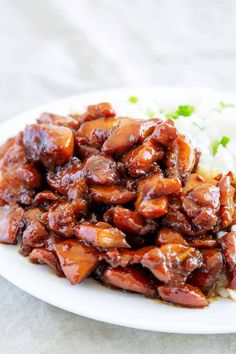 a white plate topped with meat and rice