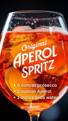 Original Aperol Spritz recipe highlighted in a close-up of the vibrant orange drink. The simple ingredients are listed: 3 ounces of Prosecco, 2 ounces of Aperol, and 1 ounce of soda water. A perfect visual for mastering this iconic Italian cocktail.