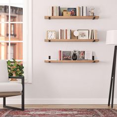 a living room filled with furniture and bookshelves on top of wooden shelves next to a window