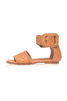 These leather sandals are made to order from high quality soft leather. Delight in the craftsmanship of these jaw dropping Madagascar leather sandals. Featuring woven leather upper with braided accents and large decorative leather bound buckle these sandals will keep you sleek and chic anywhere you go. Style them with your mini wrap dress to elevate your everyday casual look or with your floaty maxi skirt for a super chic style. -Smooth leather lining and insole with embossed logo -Lightly padde Woven Leather Ankle Strap Sandals, Bohemian Sandals With Buckle Closure And Adjustable Fit, Brown Leather Woven Sandals, Bohemian Woven Leather Beach Sandals, Bohemian Woven Leather Sandals For Beach, Natural Woven Leather Flat Sandals, Adjustable Woven Leather Closed Toe Sandals, Bohemian Sandals With Ankle Strap And Leather Sole, Bohemian Ankle Strap Sandals With Leather Sole