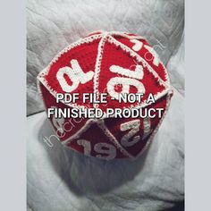 a red and white crocheted dice with the words df file not a finished product