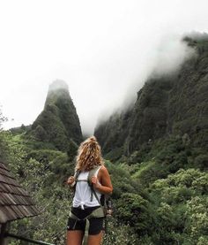 a woman hiking up the side of a mountain