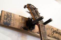 an acoustic guitar mounted to the wall