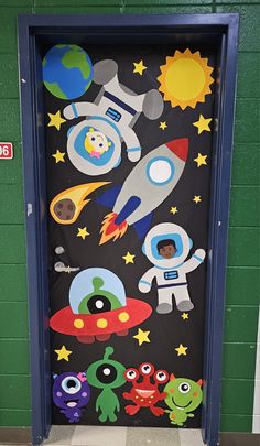 a door decorated with cartoon characters and space shuttles on the side of a building