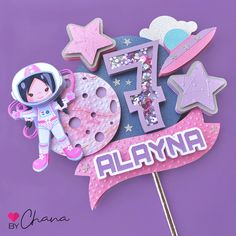 a cake topper with an astronaut on it and the number five surrounded by stars