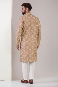 Beige silk kurta with mandarin collar, all over vintage pattern and multi color pastel chikankari thread embroidery. Paired with white straight fit pants.
Components: 2
Pattern: Embroidered
Type Of Work: Chikankari Thread and Sequin Work
Neckline: Mandarin Collar
Sleeve Type: Full Sleeves
Fabric: Silk
Color: Beige
Other Details: 
Side slits on kurta
Kurta Closure: Front concealed placket
Occasion: Wedding,Destination Wedding - Aza Fashions Kurta For Men, Beige Silk, Straight Fit Pants, Color Pastel, Brown Silk, Fashion App, Thread Work, Kurta Set, Embroidered Silk