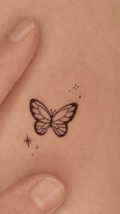 a small butterfly tattoo on the stomach