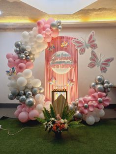 an arch made out of balloons and flowers