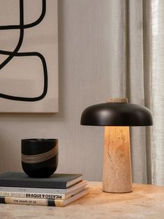 a table topped with books and a lamp