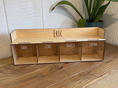 a wooden shelf with three empty bins on it and the words eric save give invest spend