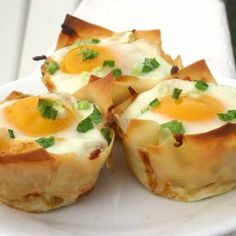 four small cups with eggs in them on a white plate