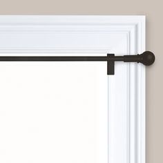 an open window with a white frame and black curtain rod on the bottom half of it