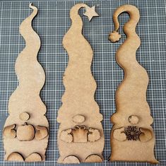 three wooden cutouts with shapes and tools