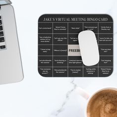 a cup of coffee next to a computer mouse and keyboard on a white table top