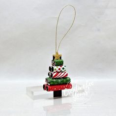 a christmas tree ornament hanging from a string