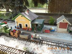 a toy train set with people on the tracks