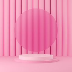 a round pink object sitting on top of a white pedestal in front of a pink wall