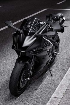 a black motorcycle is parked on the street