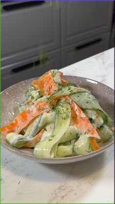 a plate with carrots, celery and cucumber in it on a table