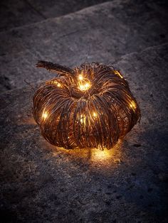 a pumpkin shaped light up decoration on the ground