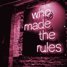 a neon sign that says who made the rules?