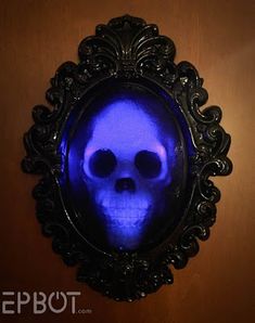 a blue skull in a black frame on a wall