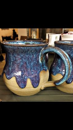 two coffee mugs sitting on top of a counter