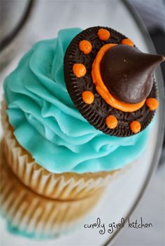 a cupcake with blue icing and orange decorations on top is featured in an instagram