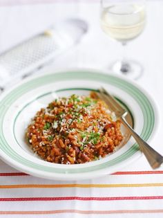 a white plate topped with rice and meat