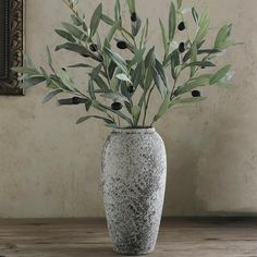 a vase that has some plants in it