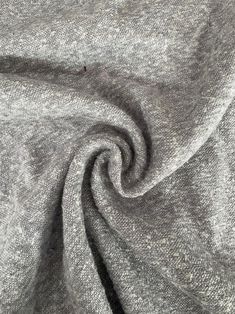 a close up view of the fabric on a grey shirting material that is very soft