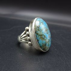 "PAUL LIVINGSTON NAVAJO BLUE MOON TURQUIOSE RING DESCRIPTION: This ring features a glorious specimen of Blue Moon turquoise. The gemstone is secure in smooth bezel, on a foundation of heavy gauge sterling silver. The substantial split-shank band is punctuated with applied raindrops. This ring will be a treasured addition to your collection of fine Native American jewelry. MEASUREMENTS: Ring face measures 1\" x 3/4\" Cabochon measures 25mm x 18mm RING SIZE: 8 1/4 WEIGHT: 12. grams SIGNED: Paul Li Vintage Turquoise Ring With Oval Cabochon, One-of-a-kind Blue Turquoise Ring, One Of A Kind Blue Turquoise Ring, Vintage Blue Cabochon Ring, Heirloom Blue Oval Cabochon Turquoise Ring, Bohemian Blue Collectible Ring, Southwestern Turquoise Cabochon Rings, Vintage Blue Cabochon Turquoise Ring, Vintage Blue Turquoise Cabochon Ring