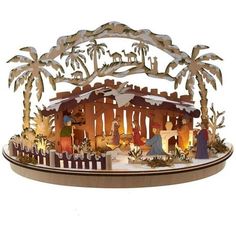 a lighted nativity scene with palm trees