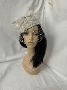 This is an elegant all white iridescent AB crystal rhinestones full size brimless pillbox hat with tiny white pearls and white sinamay swirl bow, long curled rhinestone crusted quill as accent. COGIC style beaded fancy white hat with shimmering ab rhinestones. Great for women's convention, convocation church hat, Baptist or tea party, bridal wedding hat or any other special occasion. Design to wear as a percher hat slanted to the side for a dramatic effect and with netting covering. If you perfect a more subtle look, hat can be worn with veil to the back.  Excellent Unique gift idea for the fashionista in your life who enjoys OOAK ( one of a kind), opulent, luxurious, high quality handmade wearable arts.  All year round hat Easy to wear Lightweight 22" for deeper look Fit on top of head 𝐇 Round Hat, Pearl Veil, Women Church, Birdcage Veil, Tea Party Hats, Pillbox Hat, White Hat, Church Hats, Wedding Hats