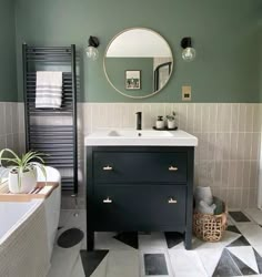 a bathroom with a sink, mirror and bathtub in the middle of the room