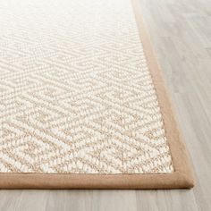 a beige and white rug on the floor