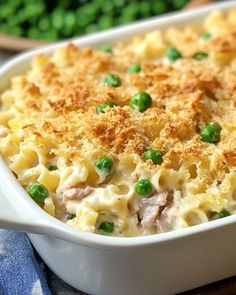 a casserole dish with peas and meat in it