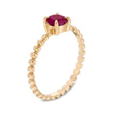 Dainty and feminine, this ruby bead shank ring in 10K gold sets an elegant tone. Crafted in warm 10K gold The 5.0mm bright red ruby center stone shines atop the sculpted beaded shank. Available in size 7 only. Due to the continuous design, this ring cannot be resized after purchase. Ruby Birthstone Ring With Round Stone, Birthstone Ruby Ring, Yellow Gold Ruby Bead Jewelry, Yellow Gold Ruby Ring With Round Stone, Stackable Ruby Ring In Fine Jewelry Style, Elegant Stackable Ruby Birthstone Ring, Stackable Red Ruby Ring In 14k Gold, Stackable Yellow Gold Ruby Ring With Round Cut, Red 14k Gold Stackable Ruby Ring