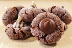 several chocolate cookies with white frosting on top